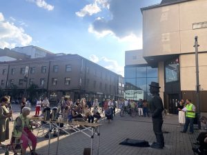 people at the market square listening a speech