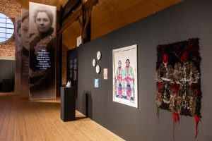 Exhibition view, on the front textile works on the wall